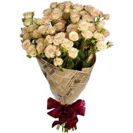 Cream spray roses in the newspaper