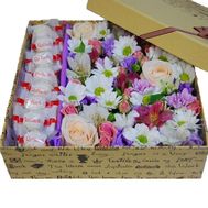 Composition of flowers in box with Raffaello