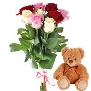 A small bouquet of roses and a bear
