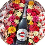 Flowers and champagne in a round box