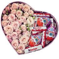 Cream roses and sweets in a box