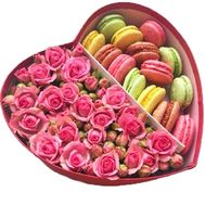 Roses and macarons in a box in the shape of a heart