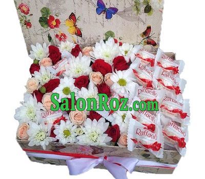 A box of flowers and Raffaello sweets A box of flowers and Raffaello sweets